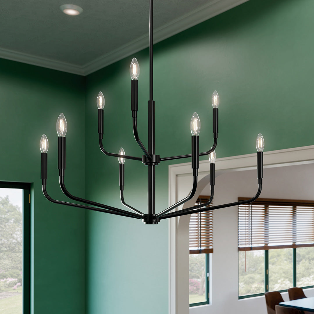 Black Kichler Madden chandelier over a dining table in a green room