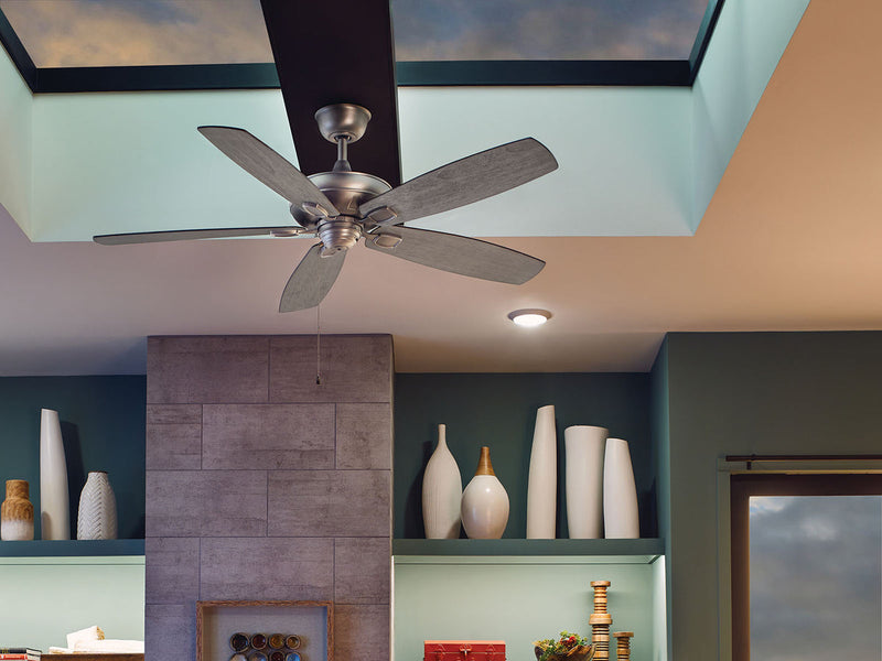 Ceiling fan in a living room with built-in shelves