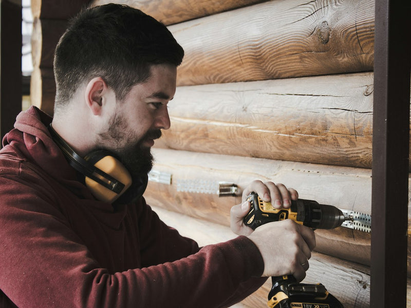 Carpenter using a cordless drill